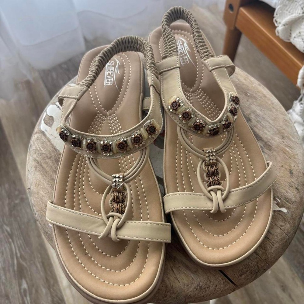 beige sandals with brown beaded embellishments